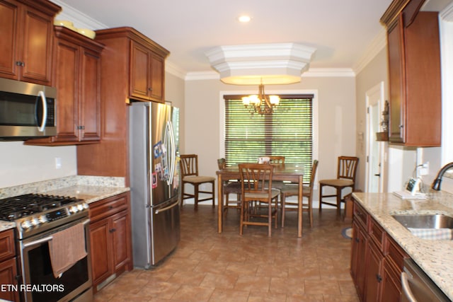 184 Danielle Ct, Harrogate, TN 37752 - kitchen featuring light stone counters, a chandelier, appliances with stainless steel finishes, a sink, and crown molding