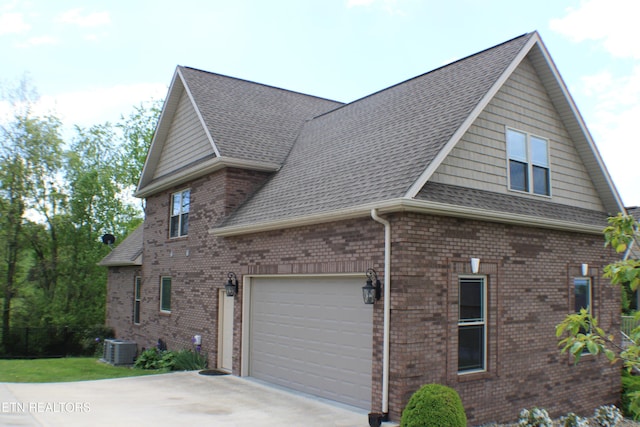 184 Danielle Ct, Harrogate, TN 37752 - view of side of home featuring cooling unit, driveway, brick siding, roof with shingles, and an attached garage