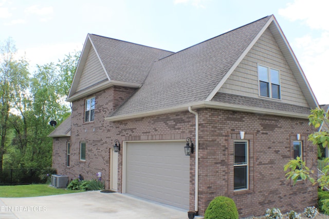 184 Danielle Ct, Harrogate, TN 37752 - view of property exterior with concrete driveway, a shingled roof, brick siding, and a garage