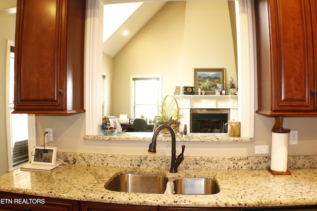 184 Danielle Ct, Harrogate, TN 37752 - kitchen featuring a sink, dark brown cabinets, light stone counters, and lofted ceiling