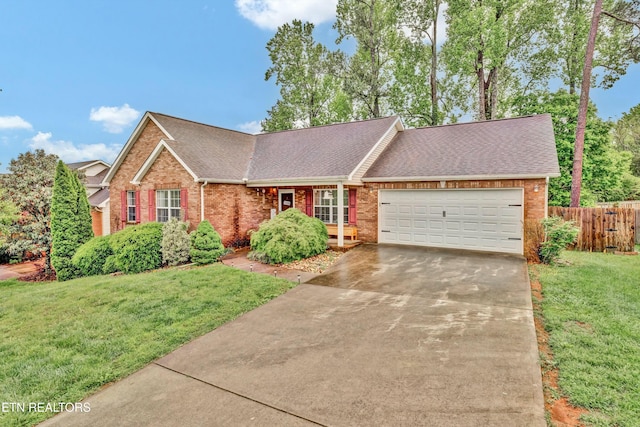ranch-style home with a garage, a front lawn, fence, brick siding, and driveway