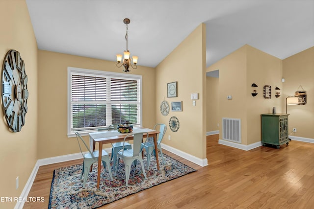 dining room with baseboards, light wood-type flooring, a chandelier, and visible vents