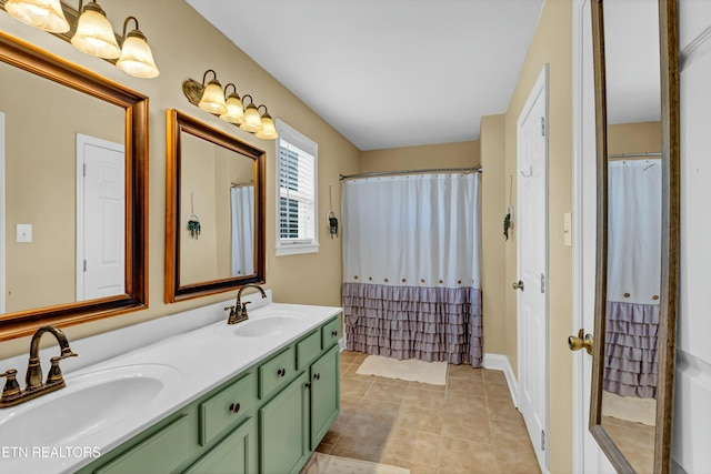 full bath with double vanity, tile patterned floors, and a sink
