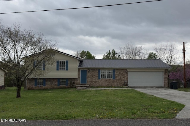 tri-level home featuring brick siding, metal roof, a garage, and concrete driveway