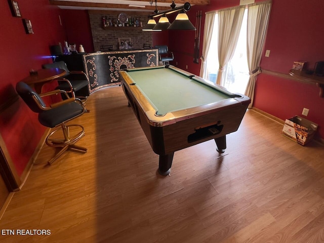 recreation room with indoor bar, wood finished floors, pool table, and baseboards