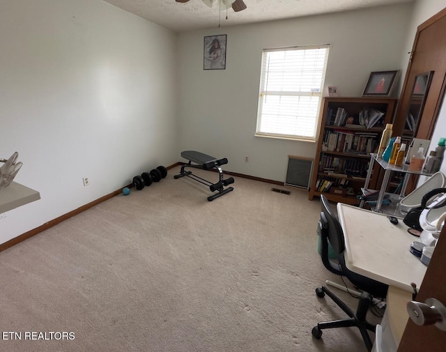 office space with baseboards, a ceiling fan, carpet flooring, and a textured ceiling
