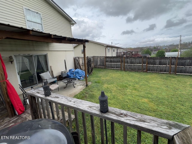 view of yard with a fenced backyard and a fire pit