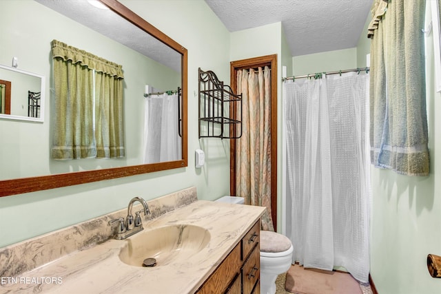 full bathroom featuring curtained shower, a textured ceiling, toilet, and vanity