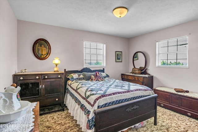 bedroom featuring light carpet and multiple windows