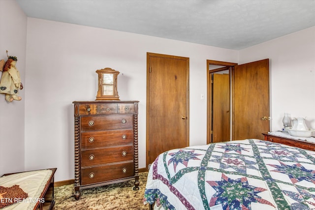 bedroom featuring carpet floors and baseboards
