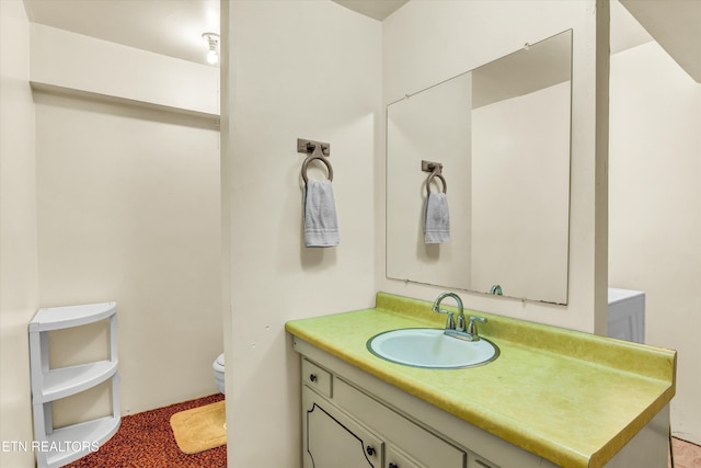 bathroom with toilet and vanity
