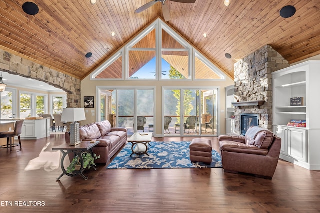 living area with wood ceiling, a fireplace, high vaulted ceiling, and a ceiling fan