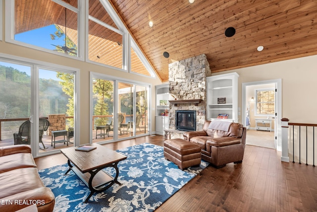 living room with a fireplace, wood finished floors, high vaulted ceiling, and wooden ceiling