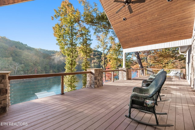 deck featuring ceiling fan and a mountain view