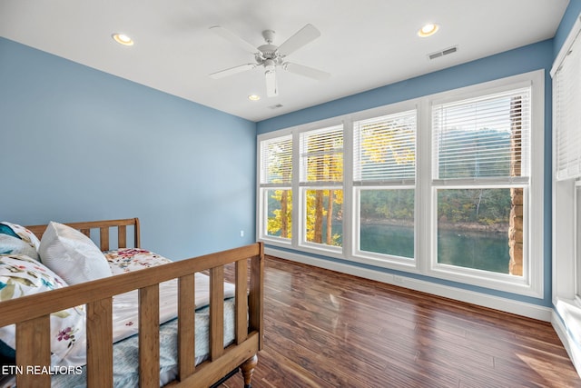 bedroom featuring baseboards, wood finished floors, visible vents, and recessed lighting