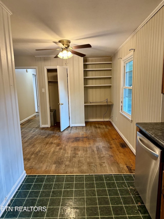 321 Walnut Valley Rd, Clinton, TN 37716 - unfurnished dining area featuring dark wood finished floors, a ceiling fan, baseboards, and wood walls