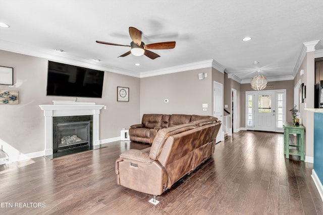 living area with a fireplace with flush hearth, ceiling fan, baseboards, recessed lighting, and wood finished floors