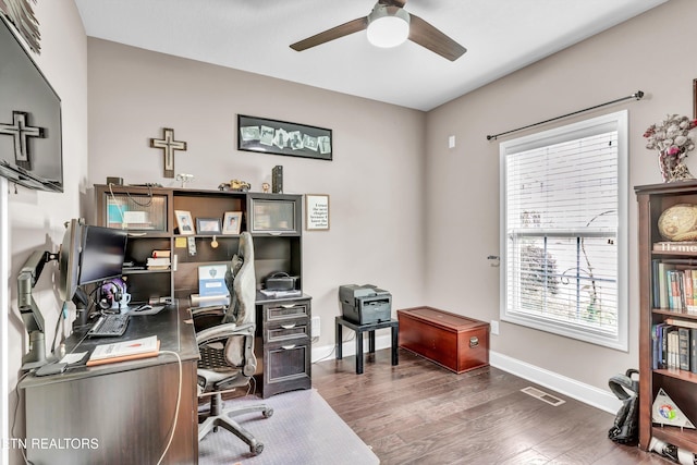 office with ceiling fan, baseboards, wood finished floors, and visible vents