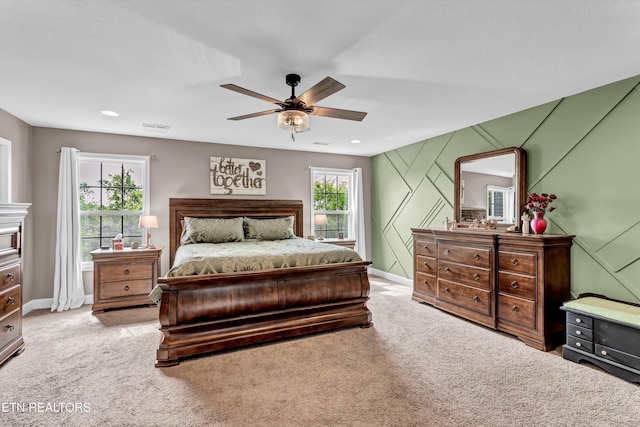 bedroom with visible vents, ceiling fan, light colored carpet, and baseboards