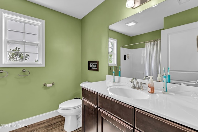 full bathroom with vanity, toilet, baseboards, wood finished floors, and a shower with shower curtain