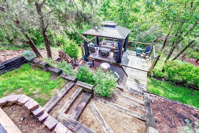 exterior space with an outdoor living space, a gazebo, and a wooden deck