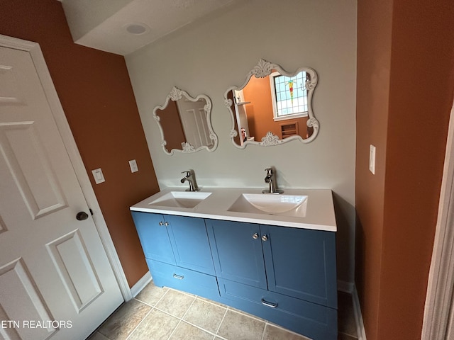 1713 Cardinal Dr, Gatlinburg, TN 37738 - bathroom featuring tile patterned floors, baseboards, double vanity, and a sink