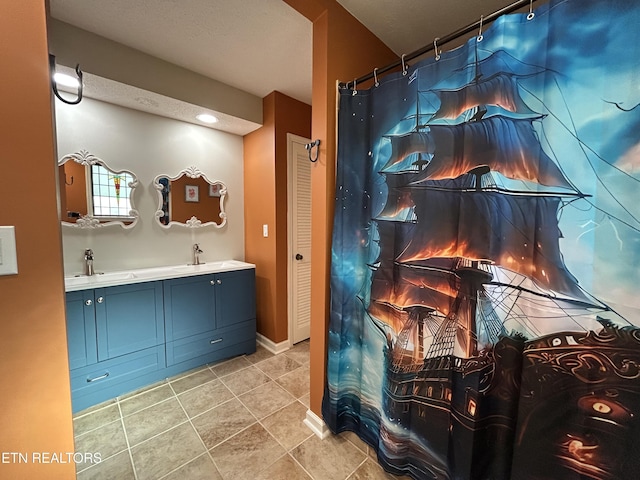 1713 Cardinal Dr, Gatlinburg, TN 37738 - bathroom with tile patterned floors, baseboards, double vanity, and a sink
