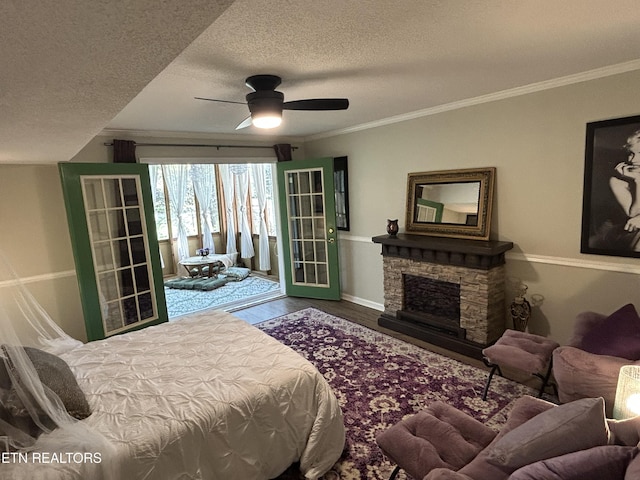 1713 Cardinal Dr, Gatlinburg, TN 37738 - bedroom with a textured ceiling, ceiling fan, ornamental molding, wood finished floors, and a stone fireplace