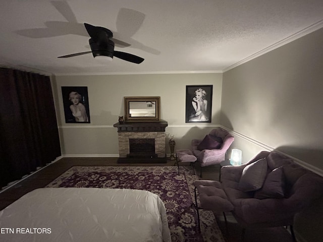 1713 Cardinal Dr, Gatlinburg, TN 37738 - bedroom featuring wood finished floors, ceiling fan, a stone fireplace, baseboards, and crown molding