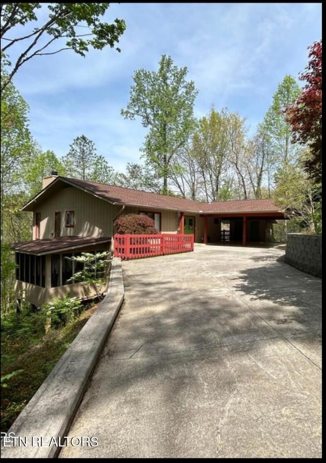 1713 Cardinal Dr, Gatlinburg, TN 37738 - ranch-style home featuring a chimney, concrete driveway, and an attached carport