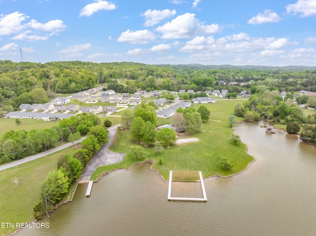 aerial view featuring a water view, a view of trees, and a residential view