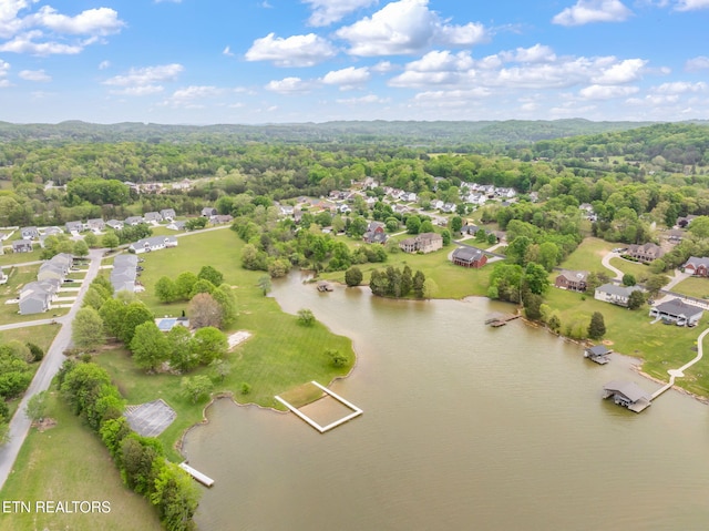 drone / aerial view with a water view, a residential view, and a wooded view