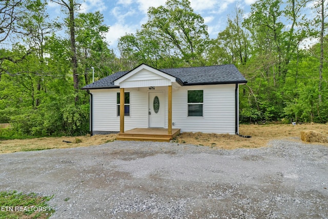 bungalow-style home with a shingled roof