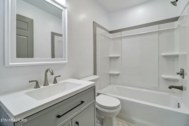 full bathroom featuring toilet, vanity, and washtub / shower combination