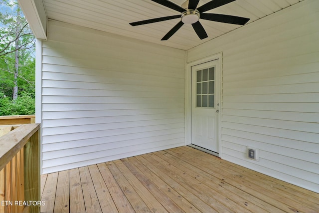 wooden terrace featuring a ceiling fan