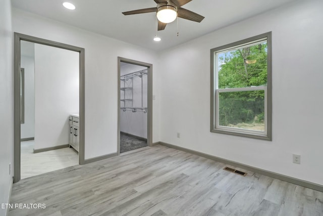 unfurnished bedroom featuring baseboards, light wood-style flooring, visible vents, and recessed lighting
