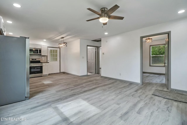 unfurnished living room with recessed lighting, baseboards, and ceiling fan