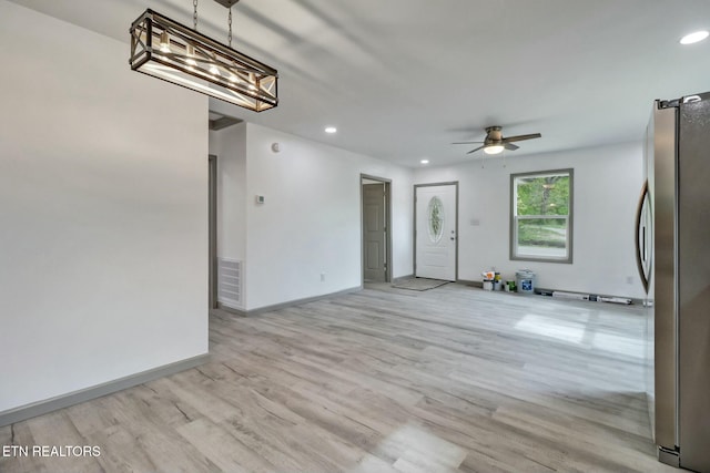 interior space featuring baseboards, light wood-style flooring, visible vents, and recessed lighting