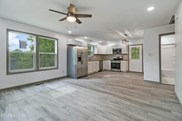 kitchen with plenty of natural light, visible vents, appliances with stainless steel finishes, and baseboards