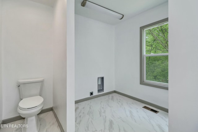 bathroom featuring baseboards, visible vents, marble finish floor, and toilet