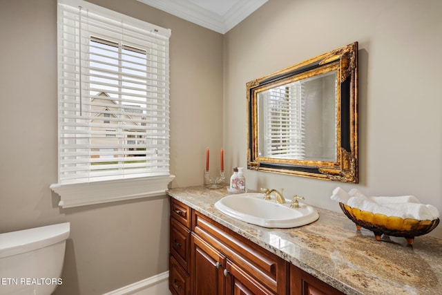 half bath featuring ornamental molding, a wealth of natural light, and toilet