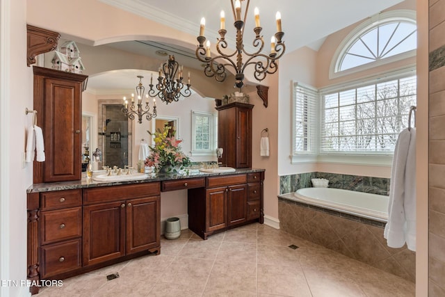full bathroom featuring a sink, tile patterned floors, a chandelier, a shower stall, and a garden tub