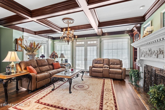 living room with wood-type flooring, a premium fireplace, beam ceiling, and a chandelier