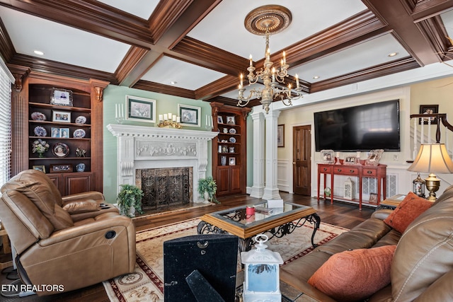 living area featuring ornamental molding, coffered ceiling, and ornate columns