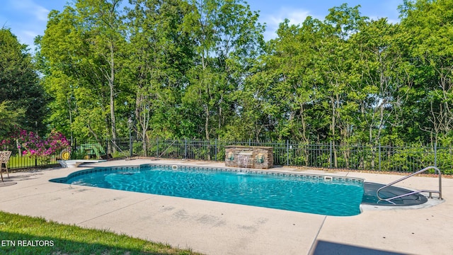 view of swimming pool featuring a fenced in pool, a patio area, and fence