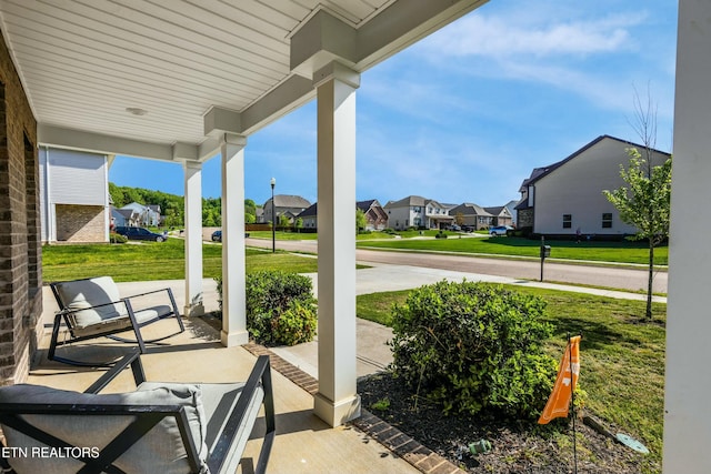 view of patio / terrace with covered porch and a residential view