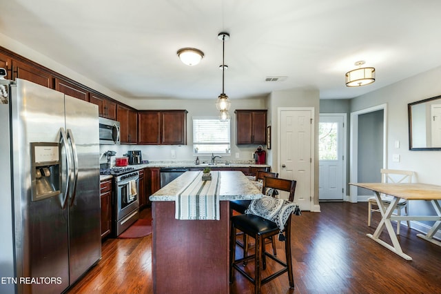 kitchen with appliances with stainless steel finishes, visible vents, a healthy amount of sunlight, and a sink
