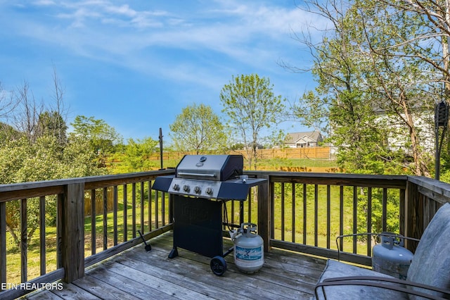 wooden terrace with a yard and a grill