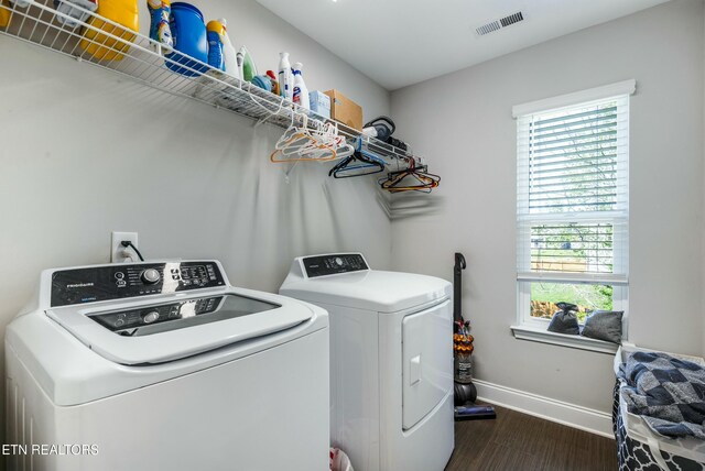 laundry room with baseboards, a healthy amount of sunlight, separate washer and dryer, and laundry area