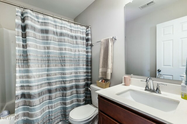 full bathroom with visible vents, toilet, a shower with curtain, and vanity